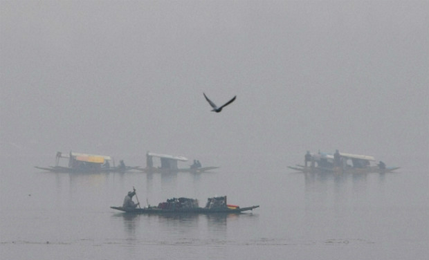 A view of Shikaras rowing in the Dal Lake on a foggy morning in Srinagar on Thursday - PTI A view of Shikaras rowing in the Dal Lake on a foggy morning in Srinagar on Thursday - PTI